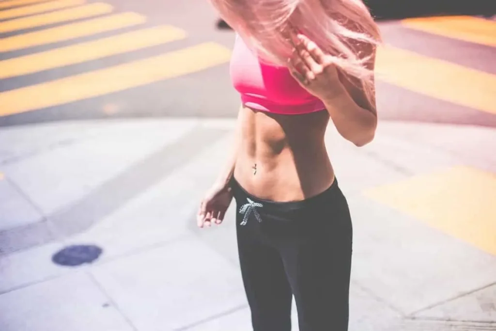 Woman with toned stomach after LA-EMS Body Sculpting Treatment Bricket Wood